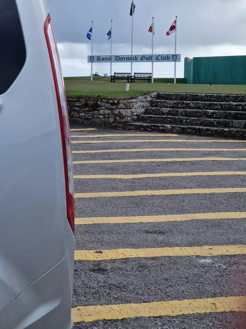 B-Direct minibus beside the entrance to Royal Dornoch Golf Club
